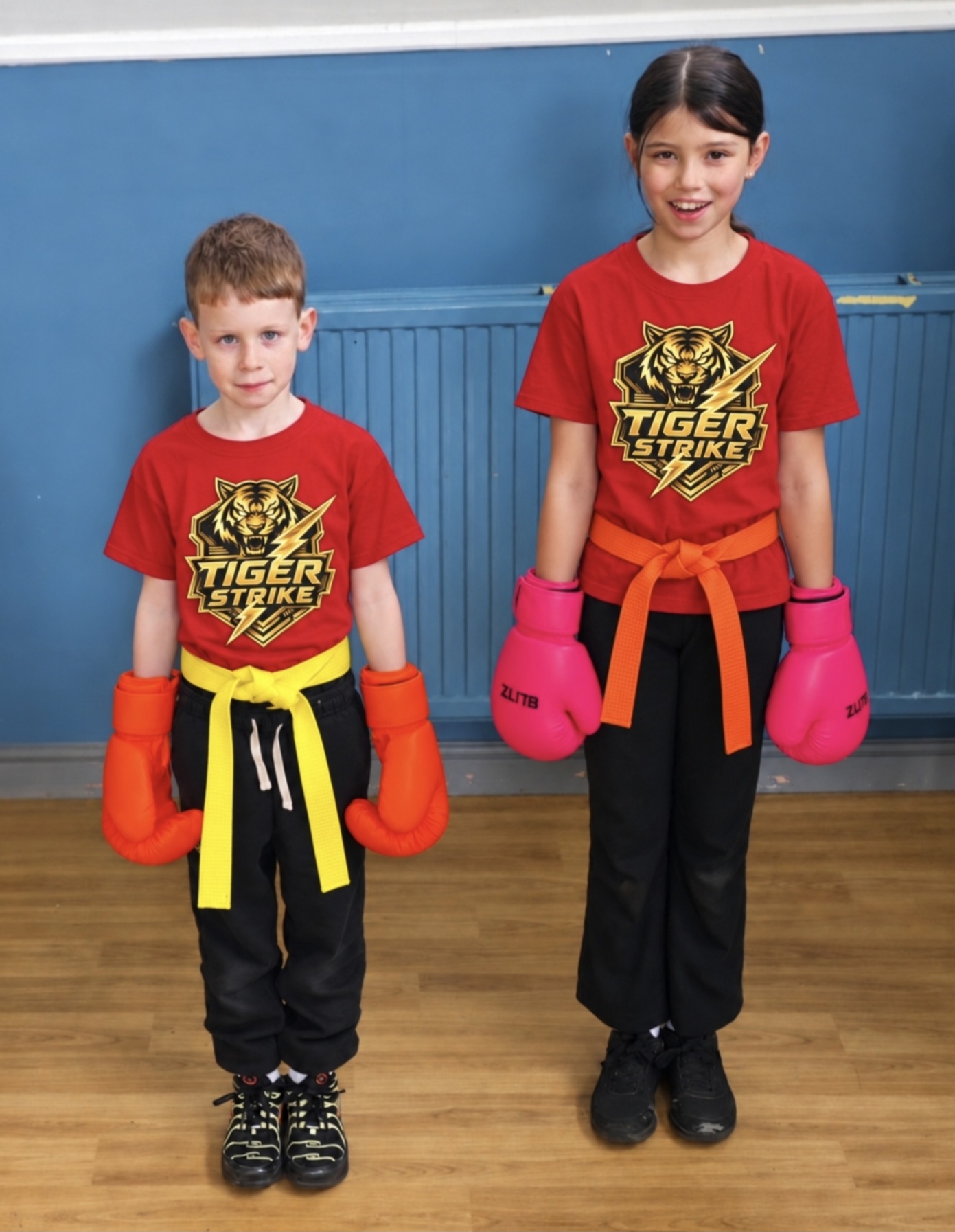 Two Tiger Strike students wearing gloves and coloured belts
